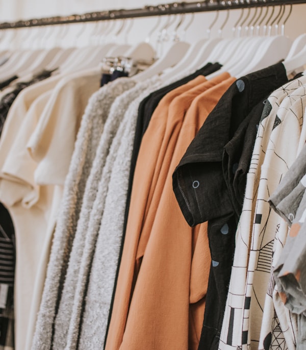 Colorful shirts and tops hanging on a clothing rack
